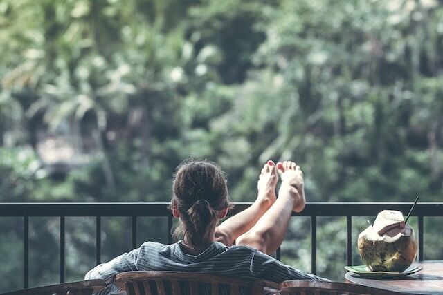 Woman sits on back patio relaxing
